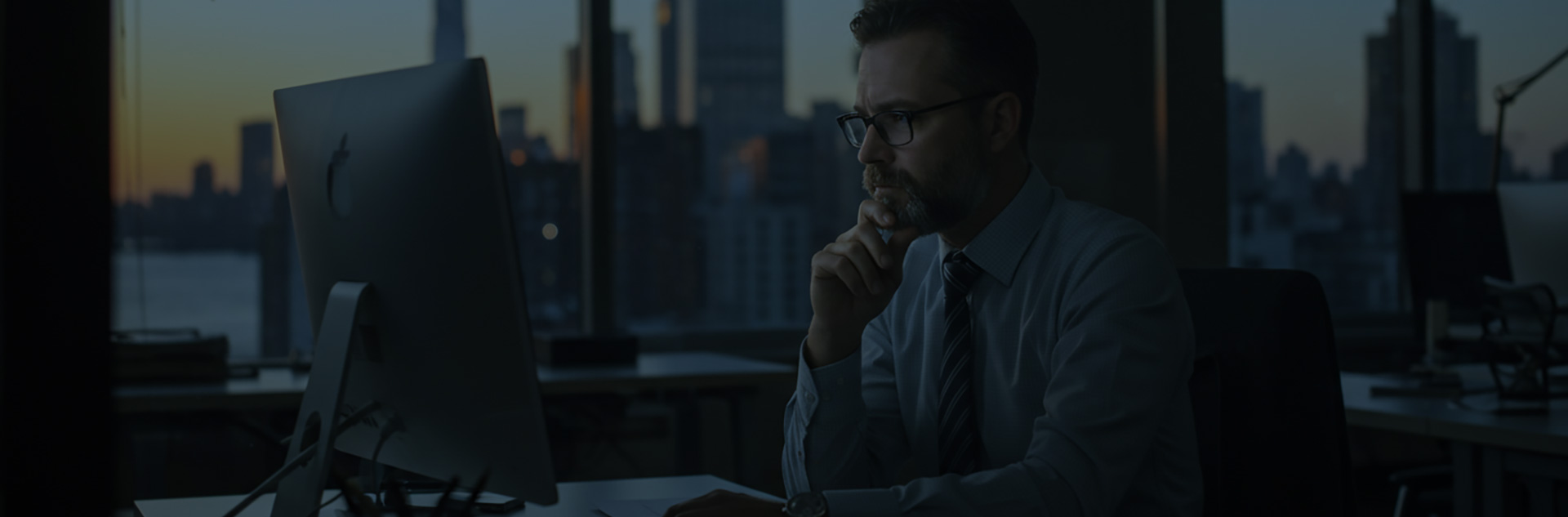 men thinking looking at desktop